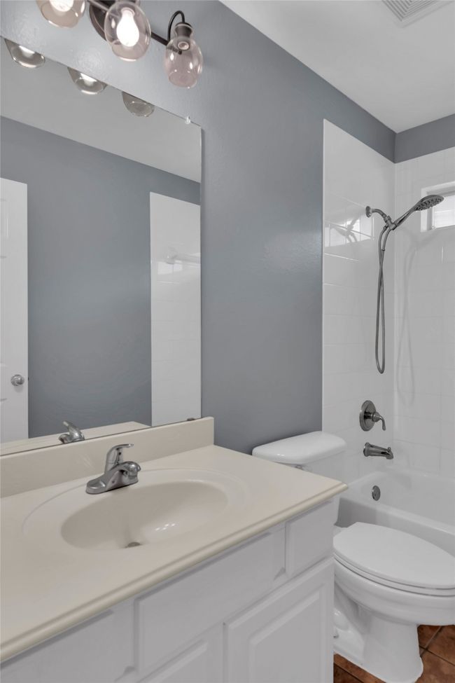 Full bath featuring vanity, bathtub / shower combination, and tile patterned flooring | Image 31