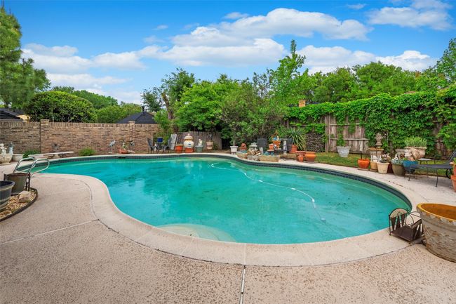 View of pool featuring a fenced in pool, a patio, and a fenced backyard | Image 19