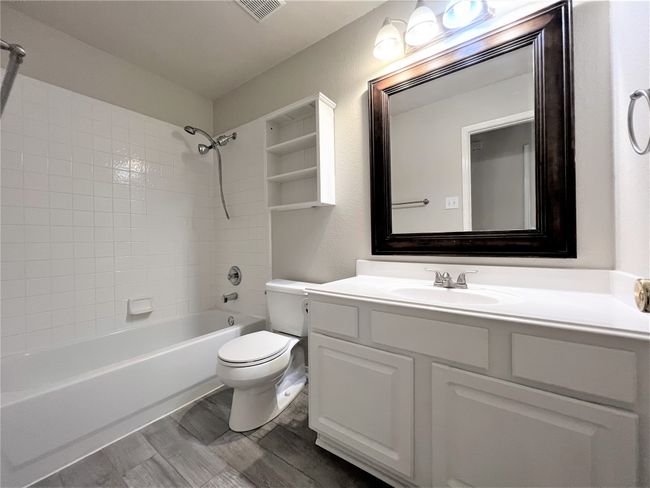 Bathroom featuring vanity and shower / washtub combination | Image 14