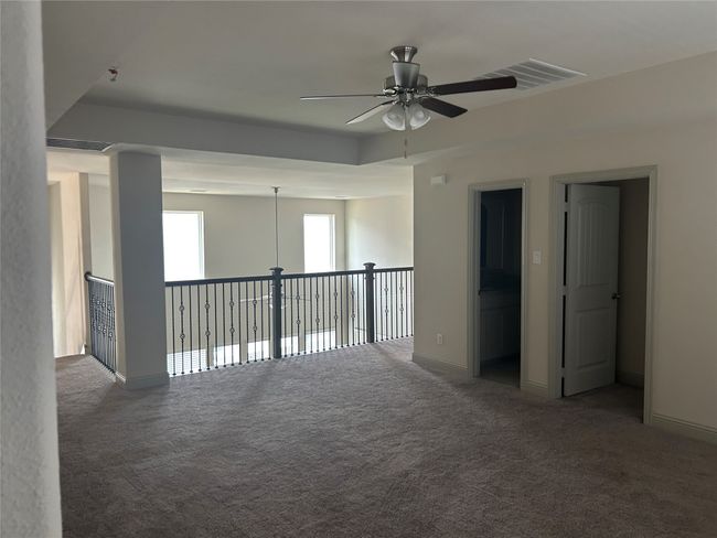 Unfurnished room featuring a ceiling fan, carpet flooring, and baseboards | Image 14