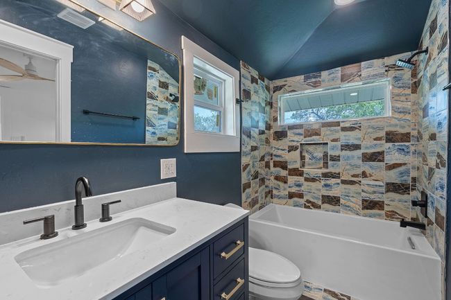 Full bath with vanity, bathing tub / shower combination, and ceiling fan | Image 15