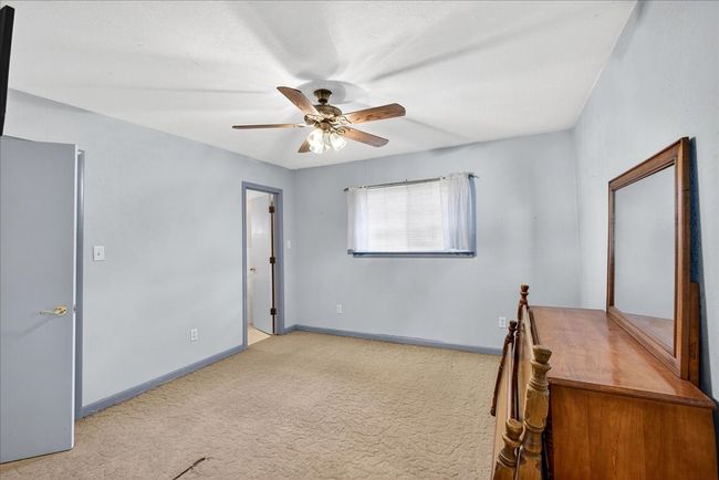 Unfurnished office with a ceiling fan and carpet | Image 22