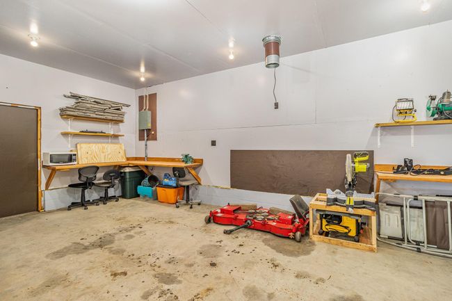This workshop (11'8"x23'6") has a 10-ft ceiling, electricity, lots of outlets, two work benches, sheet rocked walls & ceiling. A heater could be added. This space could have so many uses & possibilities. | Image 31