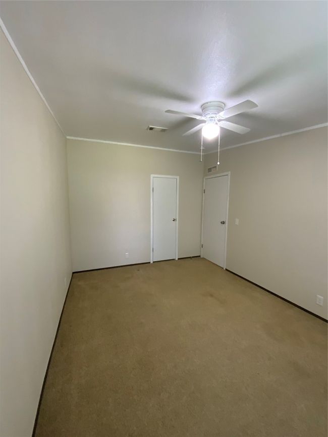 Spare room featuring light colored carpet, ceiling fan, crown molding, and visible vents | Image 28