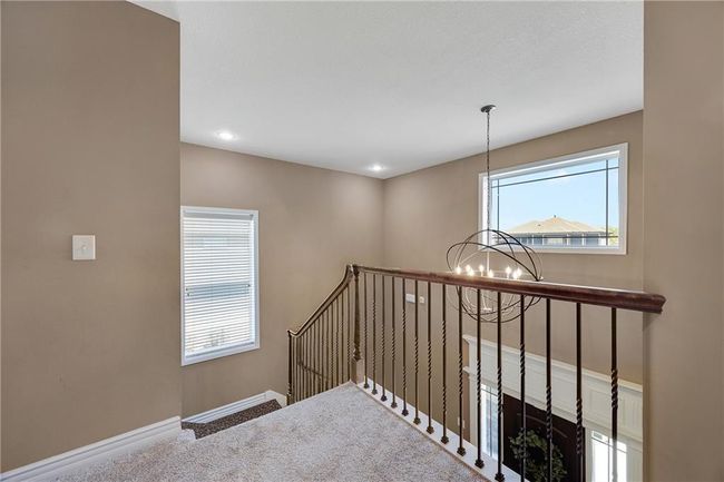 Foyer on the upper level leading to bedroooms and laundry space. | Image 20