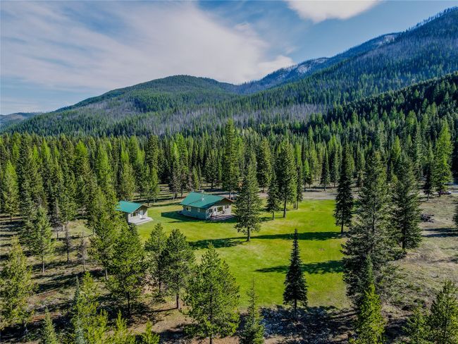 View of mountain backdrop featuring a heavily wooded area | Image 40