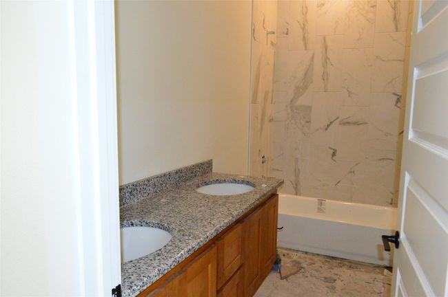 Bathroom featuring double vanity and shower / washtub combination | Image 17