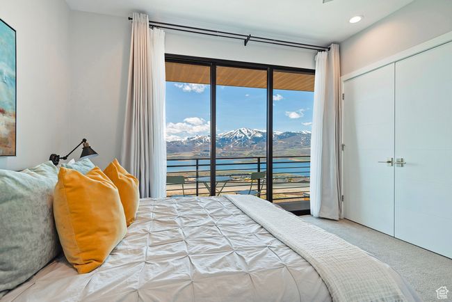 Bedroom featuring recessed lighting, access to exterior, a water and mountain view, a closet, and carpet flooring | Image 18