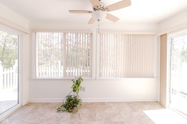 unfurnished sunroom featuring baseboards and a wealth of natural light | Image 25