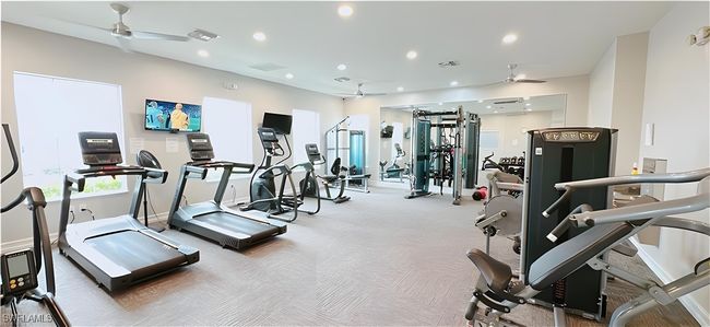 Exercise room with a ceiling fan, recessed lighting, and carpet floors | Image 24