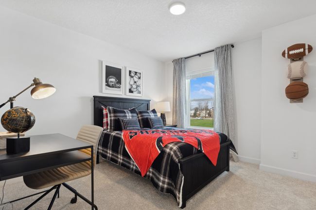 (Photo of a decorated model, actual homes finishes will vary) One of three generously sized secondary bedrooms with a spacious closet! | Image 15