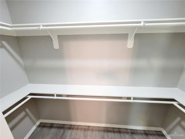 Walk in closet featuring wood finished floors | Image 12