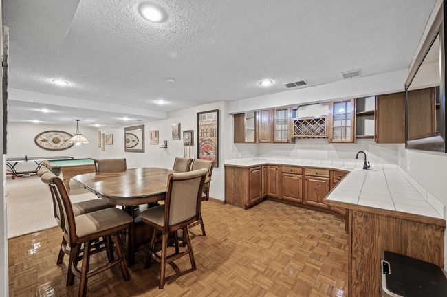 What's better than one kitchen - how about another one in the lower level - a great option when entertaining especially. Timeless, solid wood, custom cabinetry and a paneled mini fridge door for a seamless look | Image 38