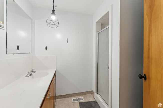 Bathroom with vanity, visible vents, and a shower stall | Image 19