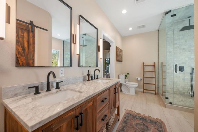 Full bathroom featuring a shower stall, double vanity, visible vents, and a sink | Image 20