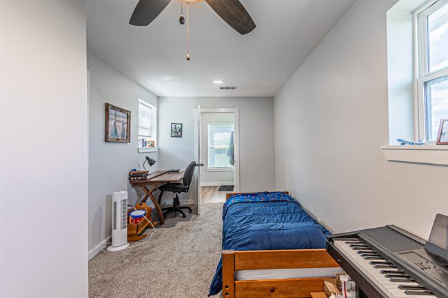 Bedroom featuring carpet flooring, a desk, and ceiling fan | Image 29