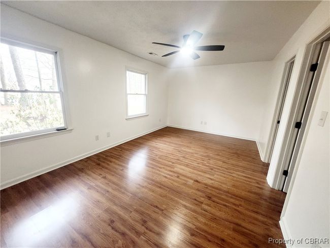 Unfurnished room featuring ceiling fan and dark hardwood / wood-style flooring | Image 6