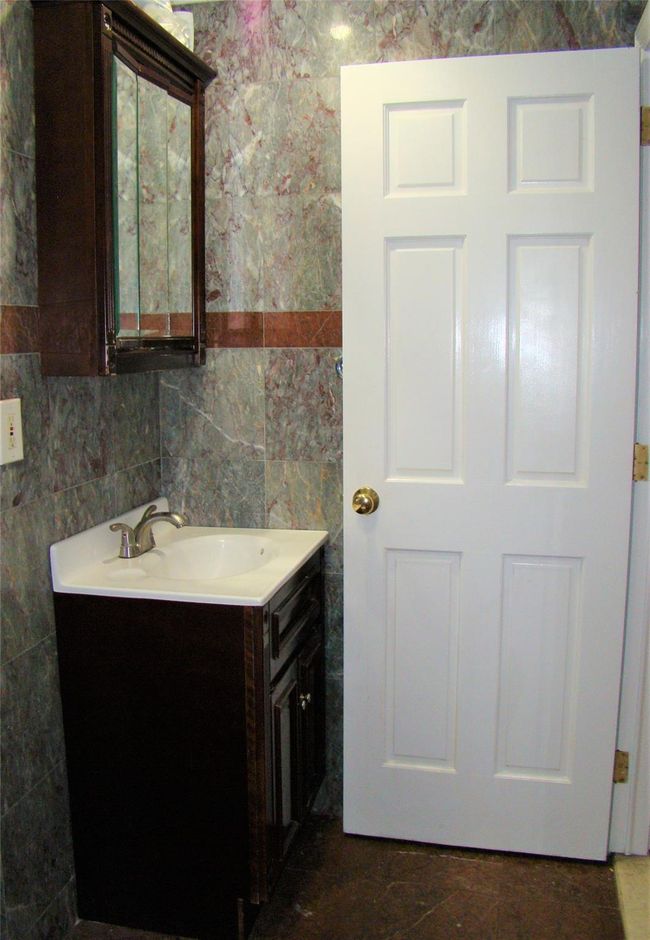 Bathroom with vanity and tile walls | Image 13