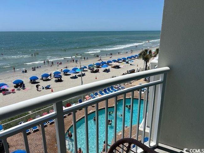 Balcony with view of water and beach and view of pool | Image 17