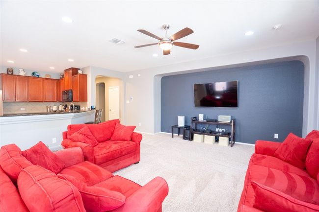 Living room featuring arched walkways, a ceiling fan, light colored carpet, and recessed lighting | Image 6