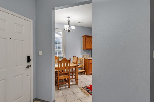 Foyer featuring light tile patterned floors and a chandelier | Image 4