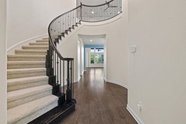 Foyer with stairs, dark wood-style floors, and a high ceiling | Image 20