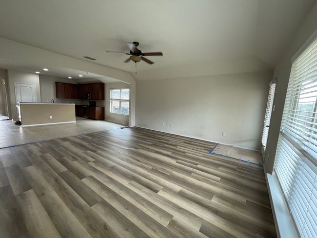Unfurnished living room featuring ceiling fan, wood finished floors, and recessed lighting | Image 17