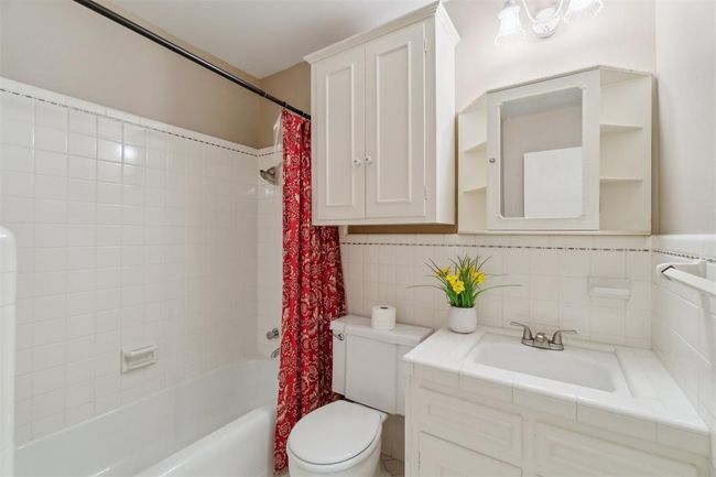 Bathroom featuring shower / tub combo, vanity, and backsplash | Image 31