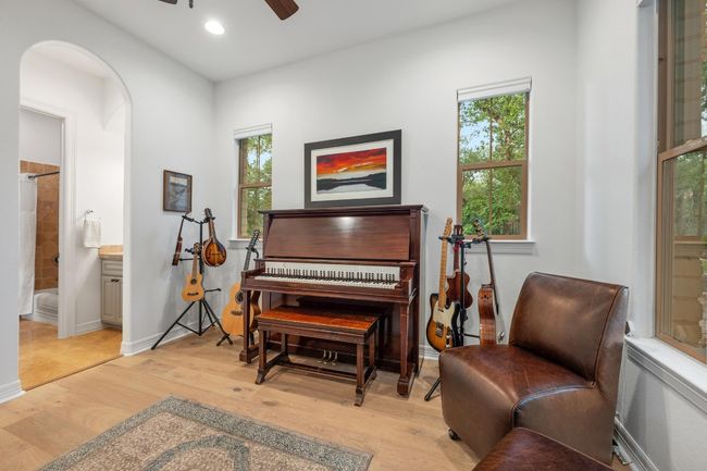 Sitting room with a ceiling fan, light wood-style floors, plenty of natural light, arched walkways, and recessed lighting | Image 26