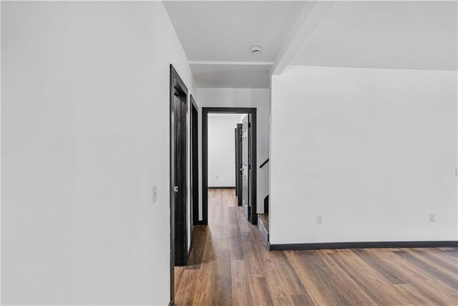 Hallway featuring wood finished floors and baseboards | Image 29