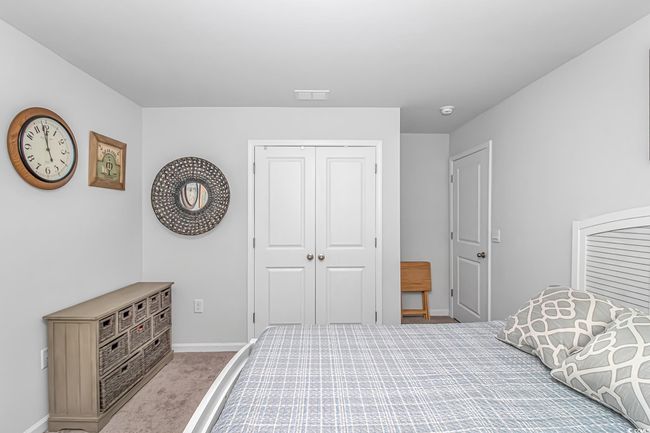Bedroom with light carpet and a closet | Image 17