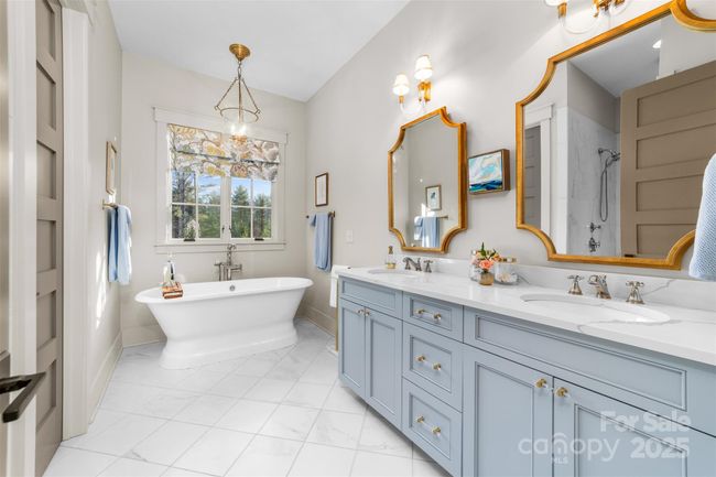 Primary suite bath offers full shower, double vanity and luxurious soaking tub. | Image 11