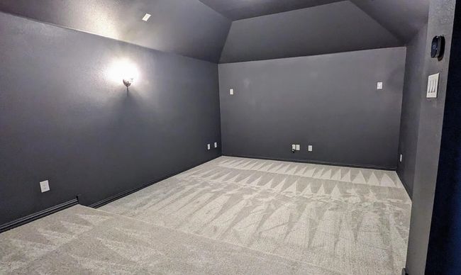 Home theater featuring vaulted ceiling and carpet | Image 21