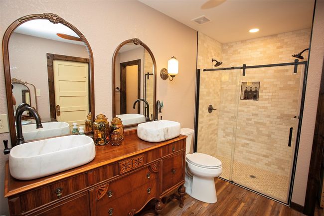 Full bath with a shower stall, wood finished floors, and double vanity | Image 37