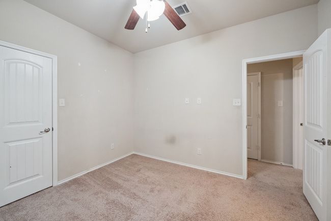 Empty room with carpet floors and ceiling fan | Image 23
