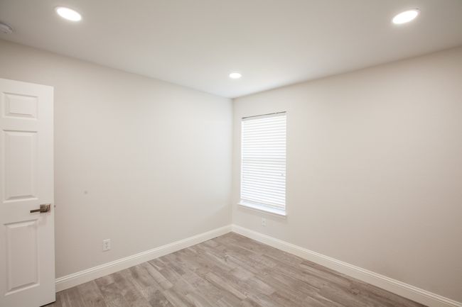 Unfurnished room featuring light wood finished floors, recessed lighting, and a smoke detector | Image 36