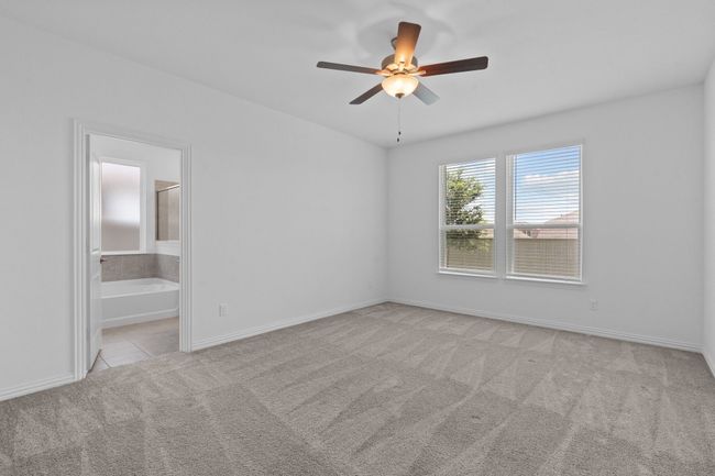 Unfurnished bedroom featuring carpet flooring, connected bathroom, and a ceiling fan | Image 21