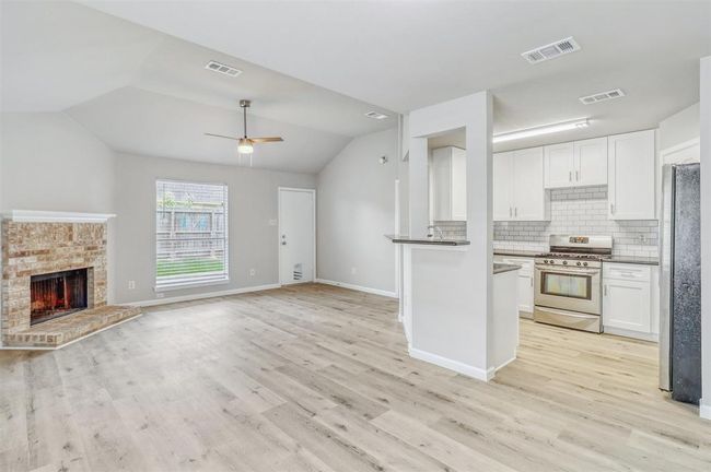 The open-concept layout seamlessly connects the main living areas, making the space feel airy, functional, and perfect for everyday living or entertaining. | Image 6