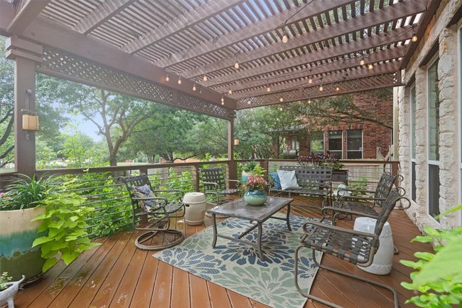 Wooden terrace featuring a pergola and an outdoor hangout area | Image 31