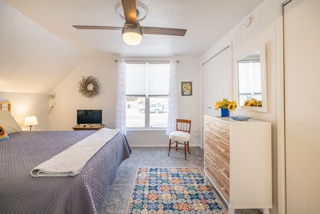 Carpeted bedroom featuring ceiling fan, vaulted ceiling, and baseboards | Image 16