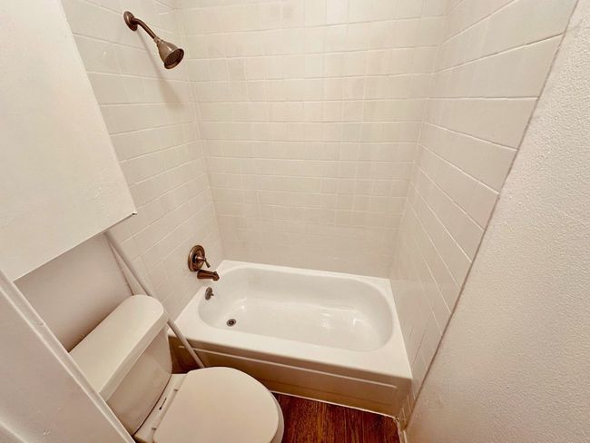 Bathroom with shower / tub combination and wood finished floors | Image 6