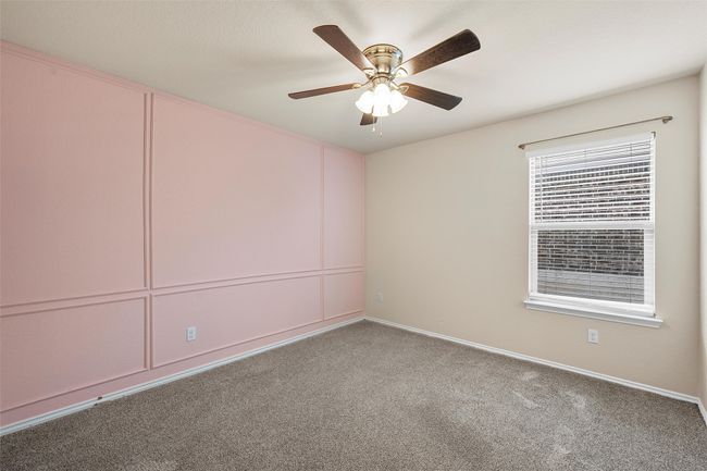 Carpeted empty room with ceiling fan and baseboards | Image 26