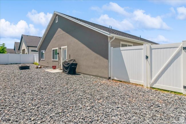 View of home's exterior with a gate and a fenced backyard | Image 28
