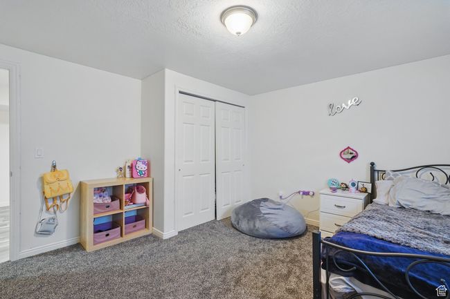 Carpeted bedroom with baseboards, a closet, and a textured ceiling | Image 34