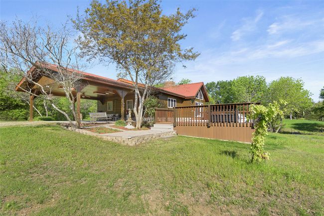 View of Carport, native landscaping, Deck and Swim Spa. | Image 20