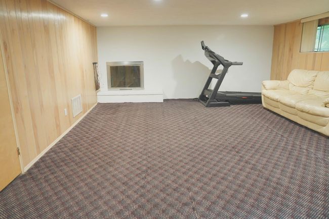 Family room with wood walls, carpet flooring, and recessed lighting | Image 14