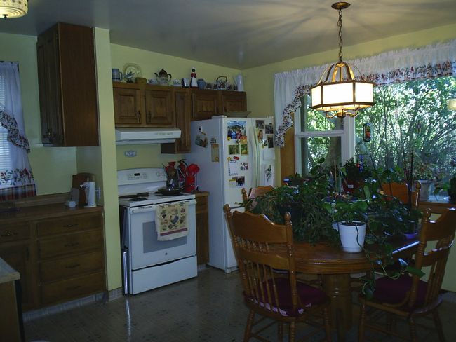 Kitchen with decorative light fixtures and white appliances | Image 15