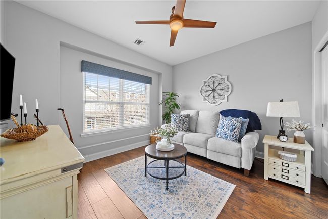 Living room featuring baseboards, visible vents, wood finished floors, and a ceiling fan | Image 14