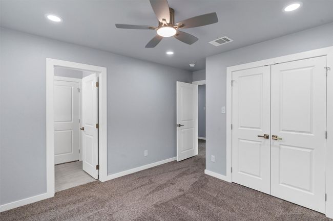 Unfurnished bedroom featuring carpet, recessed lighting, a closet, and ceiling fan | Image 36