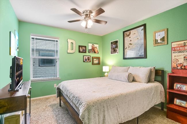 Bedroom featuring carpet flooring, a ceiling fan, and baseboards | Image 21
